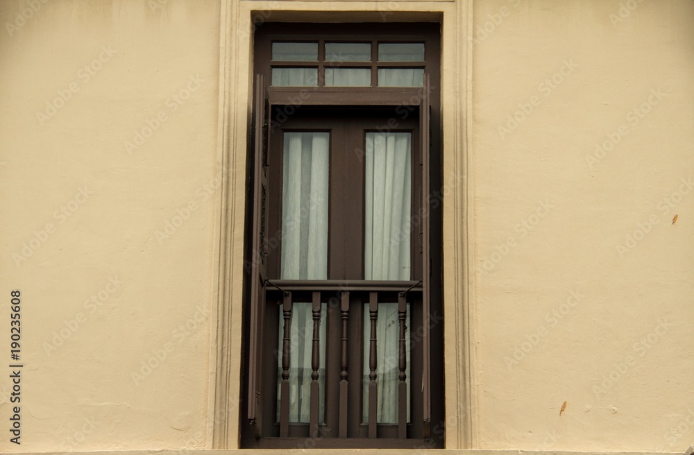 A single windows in the colonial style of Singapore.