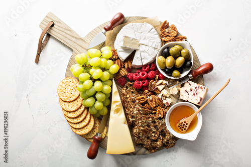 Wallpaper Mural Cheese and snacks plate on white background
