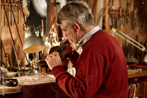 instrument maker working in his workshop