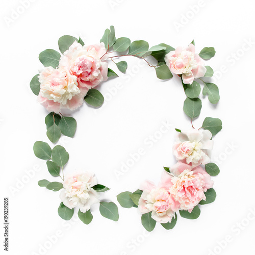 Floral round frame wreath made of pink and beige peonies flower buds, eucalyptus branches and leaves isolated on white background. Flat lay, top view. Frame of flowers. Floral background. Valentine's 