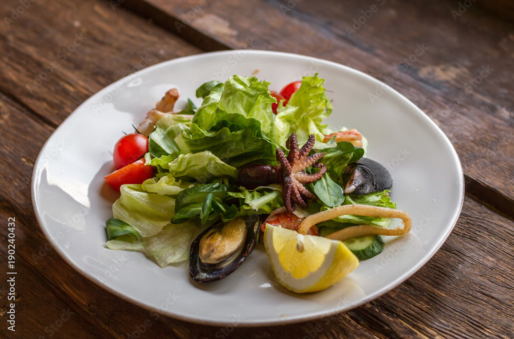 Tasty salad with seafood on a white plate Tasty salad with seafood on a white plate