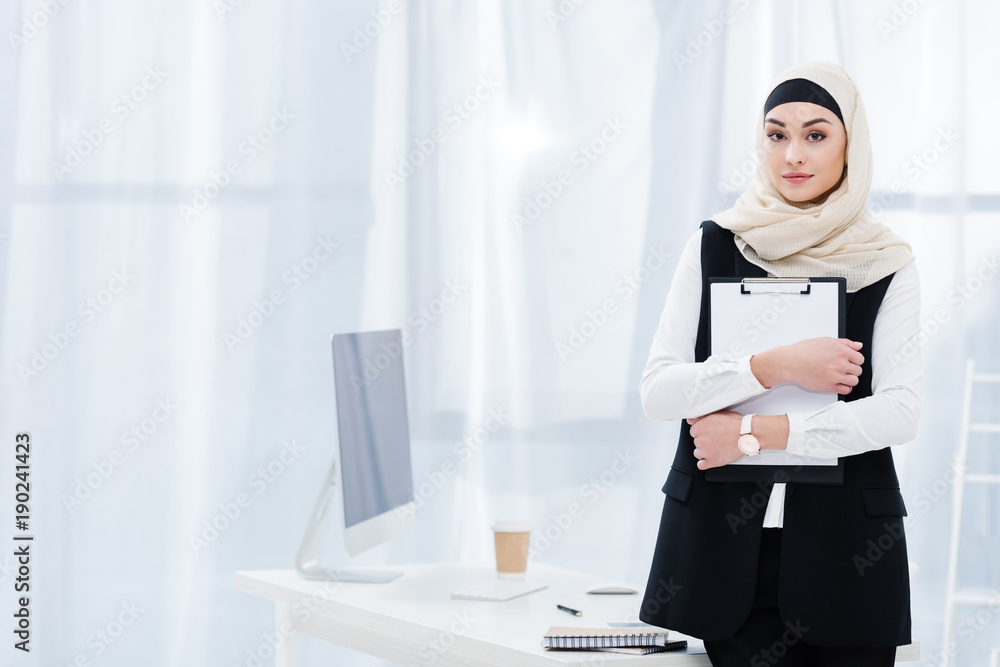 portrait of arabic businesswoman with folder in hands in office portrait of arabic businesswoman with folder in hands in office