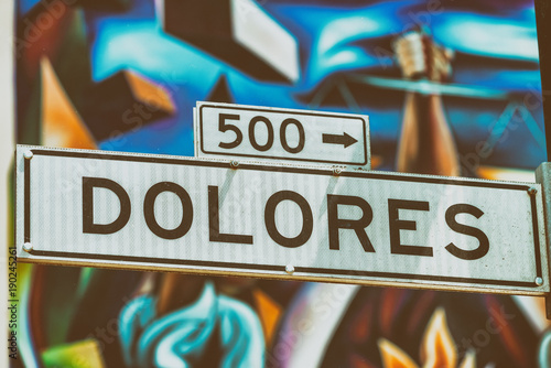 Dolores Street Road in San Francisco with blurred street art on the background photo