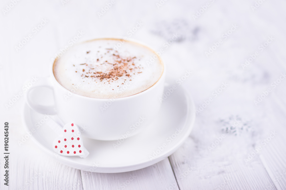 Happy Valentine's day! White cup with cappuccino and red heart on a white wooden background. Free space Happy Valentine's day! White cup with cappuccino and red heart on a white wooden background. Free space