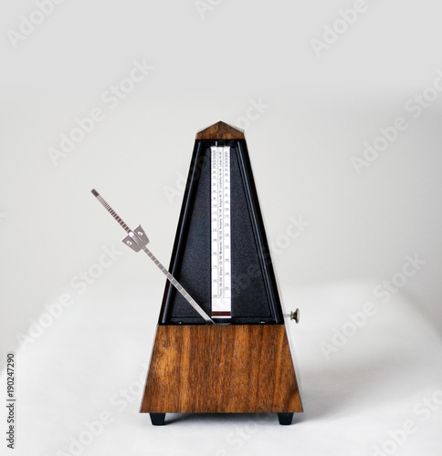 Metronome in action, closeup, isolated and on a plain background photo