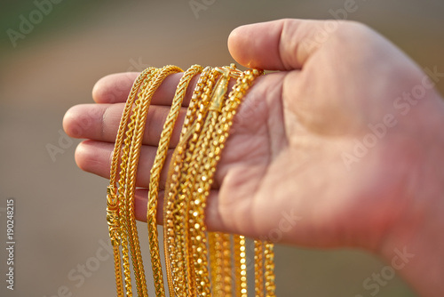 gold jewelry in lady hands.
