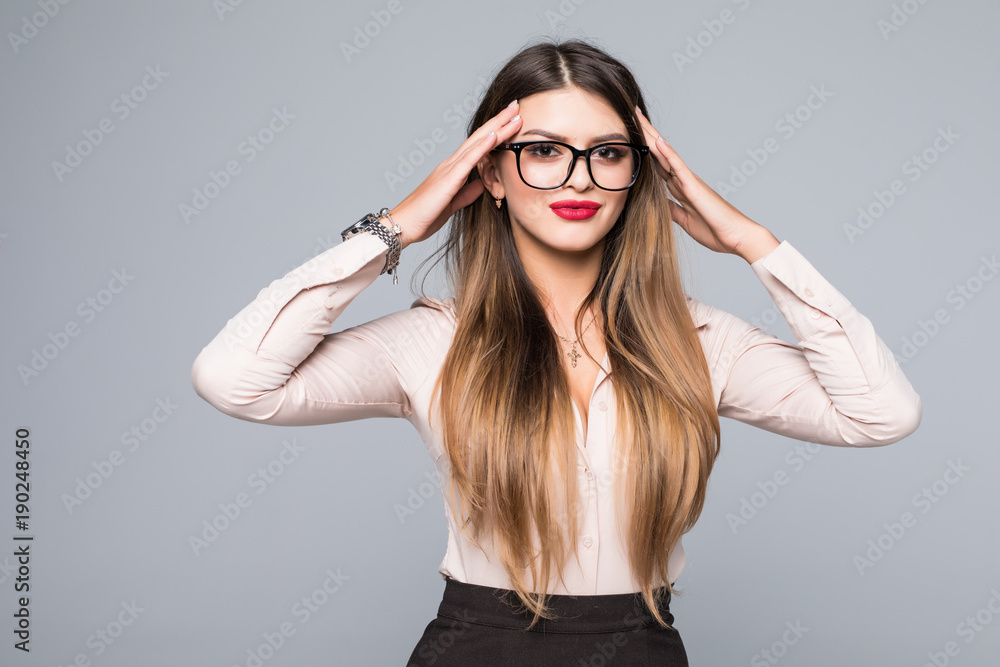 Portrait of young business woman thinking over idea, holding her head in brainstorming over gray background Portrait of young business woman thinking over idea, holding her head in brainstorming over gray background