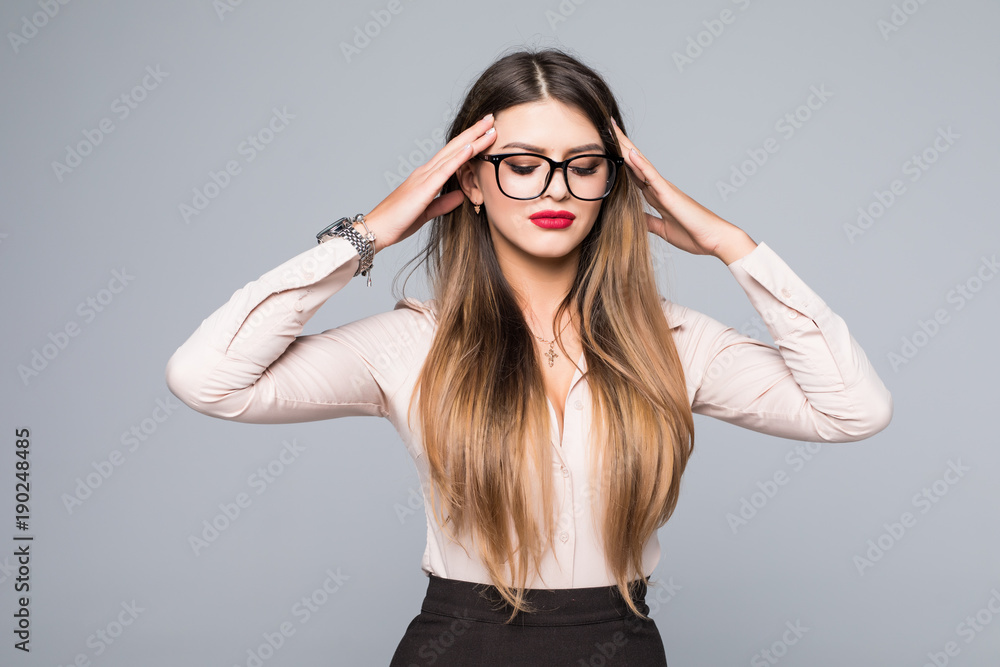 Portrait of young business woman thinking over idea, holding her head in brainstorming over gray background Portrait of young business woman thinking over idea, holding her head in brainstorming over gray background