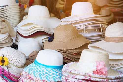 Many Hats from the sun on shopping. Beach hats colorful variety for summer. Design of women's beach hats.