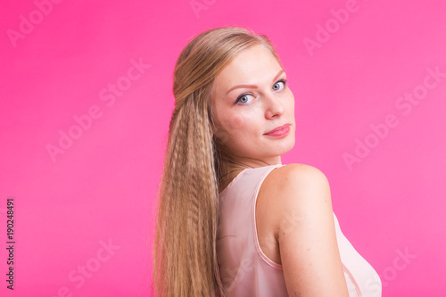 Close up portrait of a confident young blond woman smiling