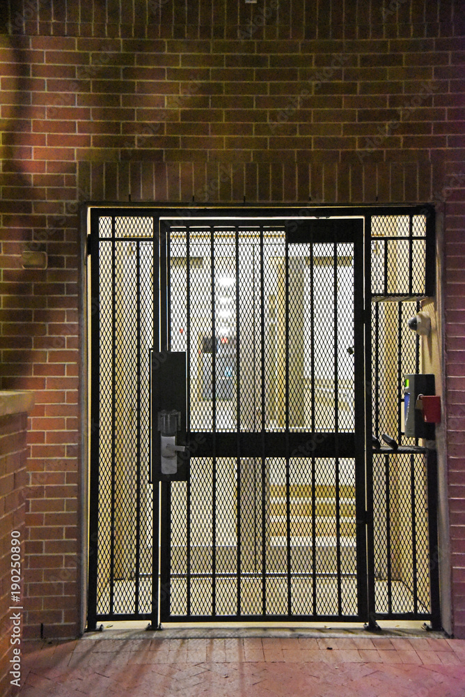 Secure door with gate and lock Stock Photo | Adobe Stock