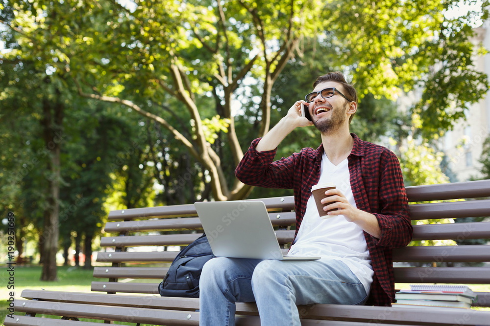Smiling man talking on mobile phone outdoors Smiling man talking on mobile phone outdoors