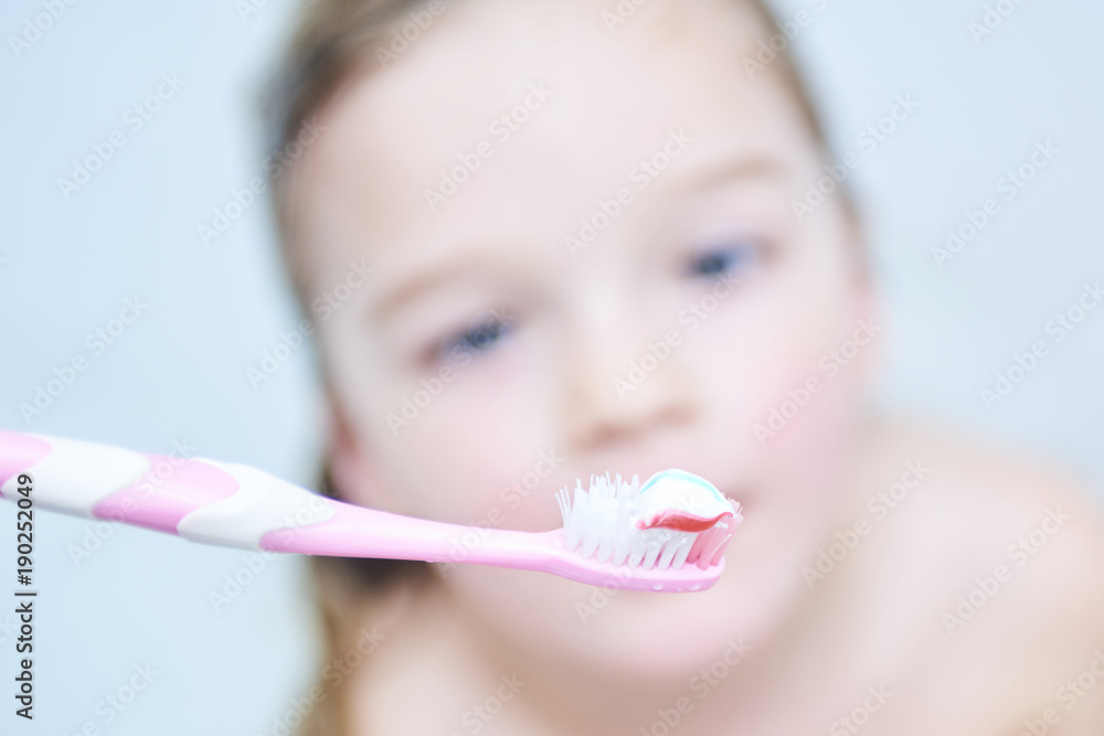 Cute smiling little girl is taking a bath holding toothbrush
Cute smiling little girl is taking a bath holding toothbrush