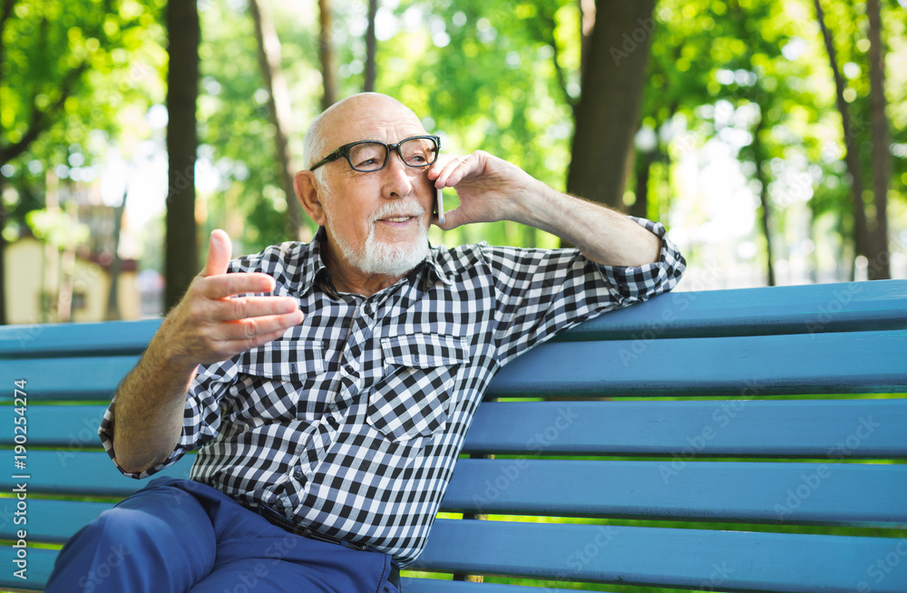 Senior man with mobile outdoors Senior man with mobile outdoors