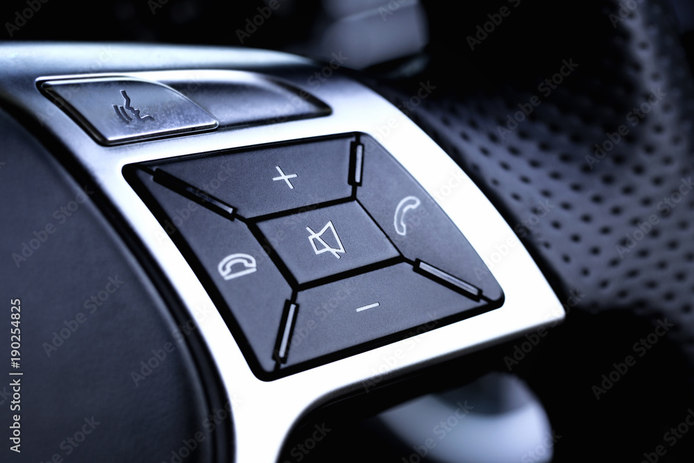 Hands free and media control buttons on the steering wheel in a modern car Hands free and media control buttons on the steering wheel in a modern car