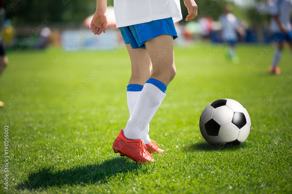 Feet of football player with soccer ball. Soccer players before kick pass to teammate