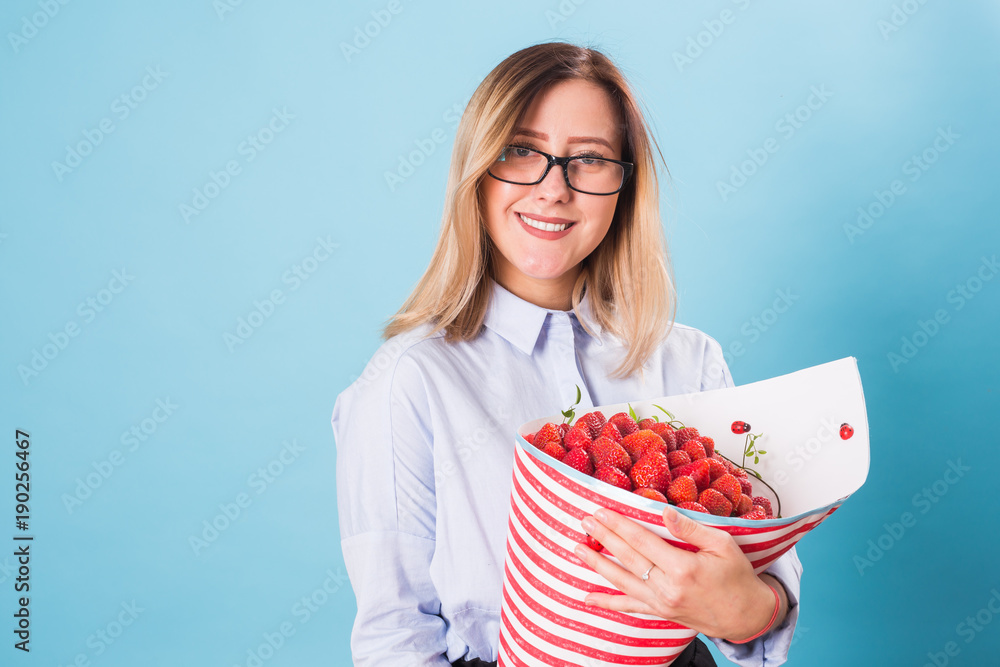 Beautiful woman holding bouquet made of strawberry Beautiful woman holding bouquet made of strawberry
