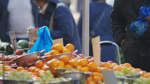 Fruit market trader giving a customer change from their purchase