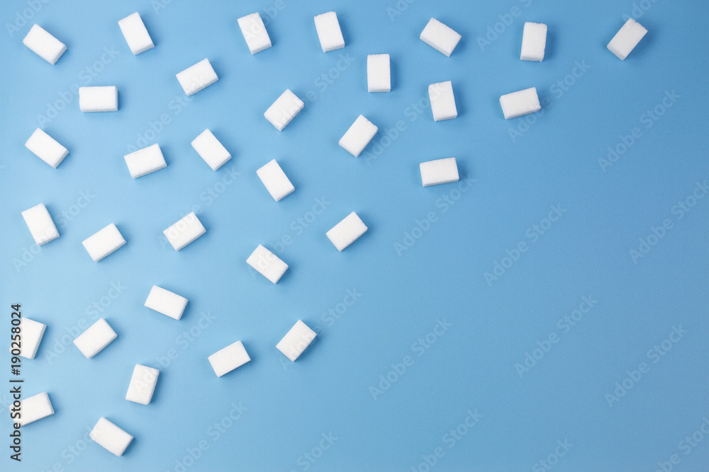 White sugar cubes on blue background White sugar cubes on blue background