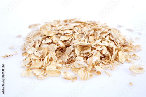 Oat flakes isolated on white. Closeup view photo