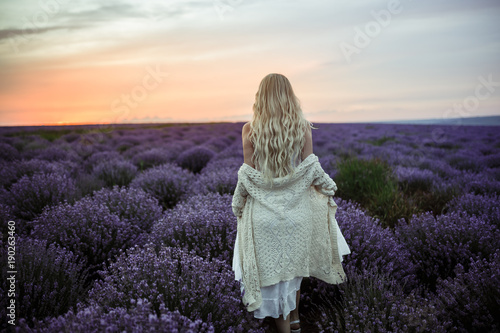 Young woman in white dress on the lavender field