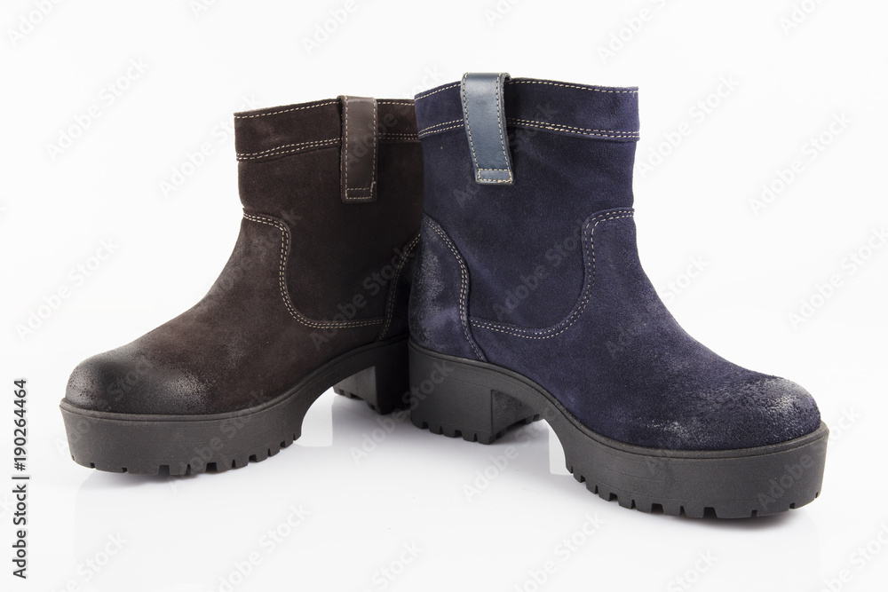 Female blue and brown leather boots on white background, isolated product, comfortable footwear.
