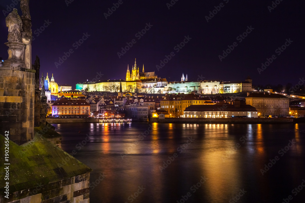 Night view of Prague in color lights: ancient historic buildings and St. Vitus Cathedral, Czech Republic