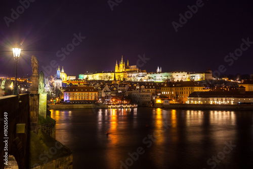 Night view of Prague in color lights: ancient historic buildings and St. Vitus Cathedral, Czech Republic