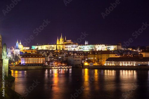 Night view of Prague in color lights: ancient historic buildings and St. Vitus Cathedral, Czech Republic