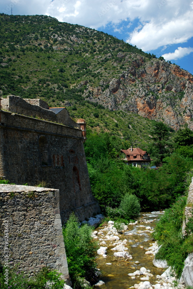The River Tet runs by the pretty walled town of Villfranche de Conflent in the south of France. This medieval city dates back to the 11th century The River Tet runs by the pretty walled town of Villfranche de Conflent in the south of France. This medieval city dates back to the 11th century
