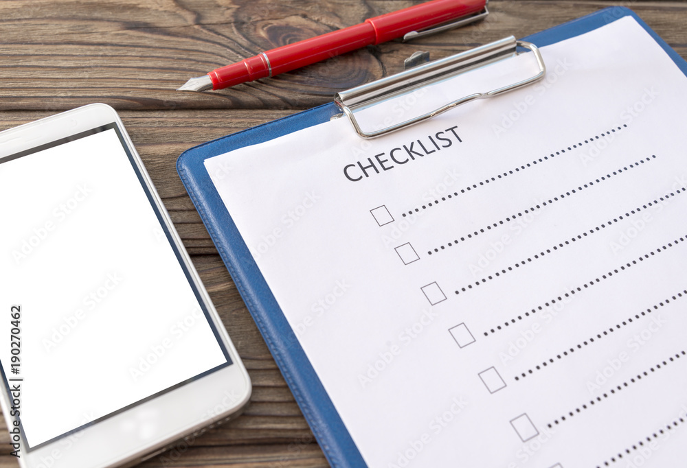control sheet on the tablet, smartphone. A handle on a wooden background with a tola. business. finance. planning control sheet on the tablet, smartphone. A handle on a wooden background with a tola. business. finance. planning