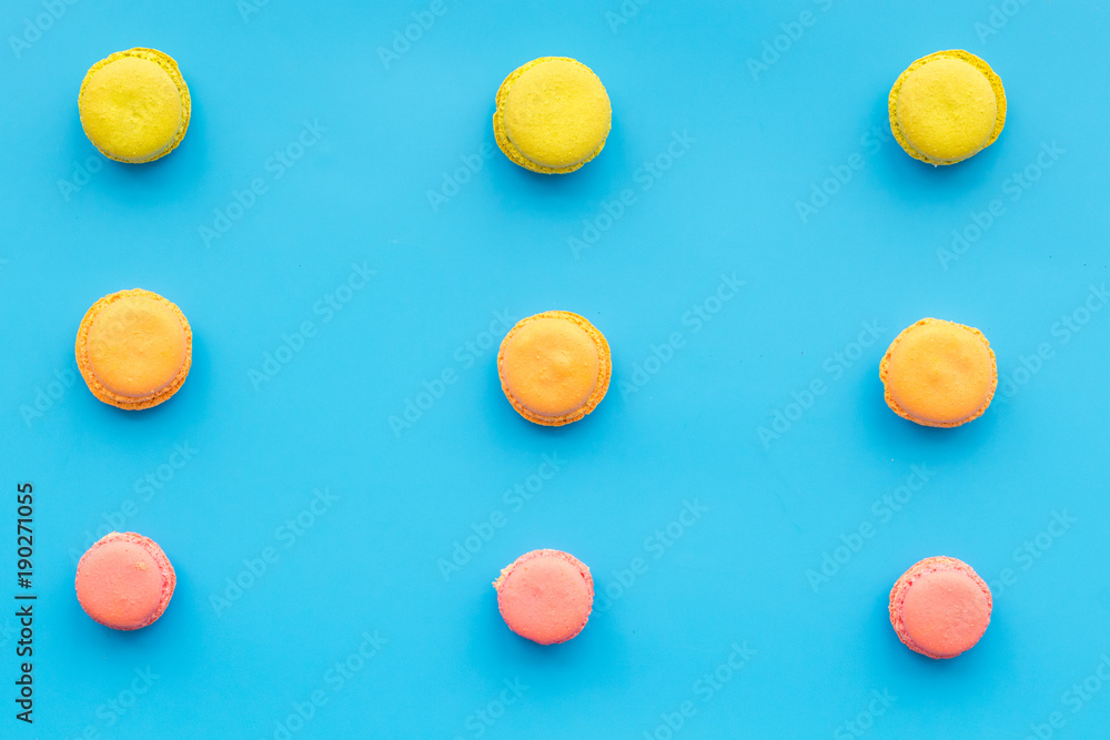 Macarons dessert. Pattern on blue pastel background top view