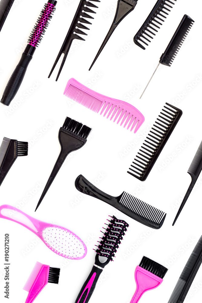 Hairdressing tools. Pattern with various combs and brushes on white background top view Hairdressing tools. Pattern with various combs and brushes on white background top view