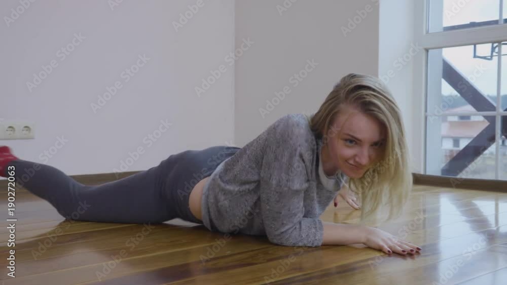 Young girl makes wave motion on the floor during dancing Young girl makes wave motion on the floor during dancing