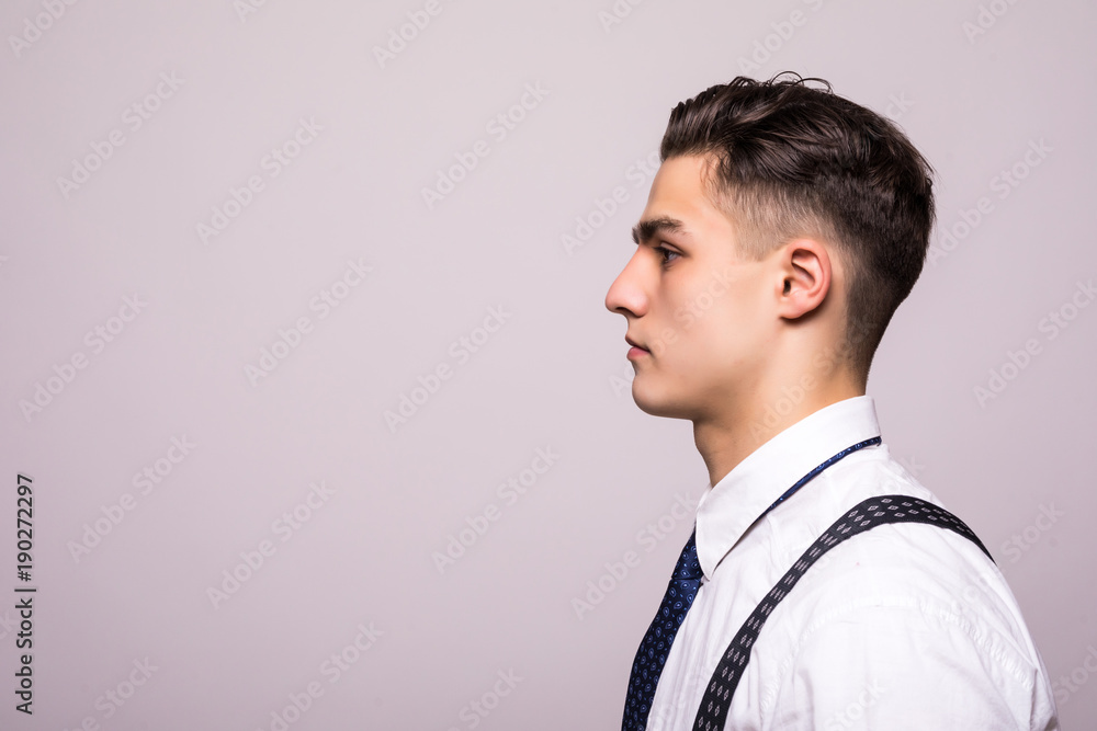 Side view portrait of confident man with beautiful hairstyle in white shirt looking on copy space isolated on white Side view portrait of confident man with beautiful hairstyle in white shirt looking on copy space isolated on white