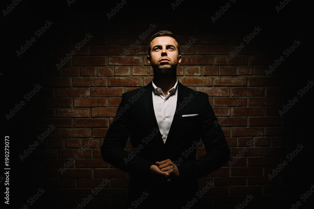 Fototapeta premium Handsome young brunette model, wearing in black and white suit, 