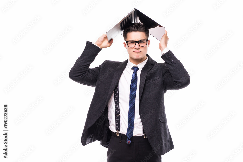Handsome businessman which holds a laptop above his head in formals standing isolated over white background Handsome businessman which holds a laptop above his head in formals standing isolated over white background