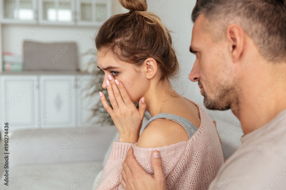 Fototapeta premium Back view of Careful man sitting on couch
