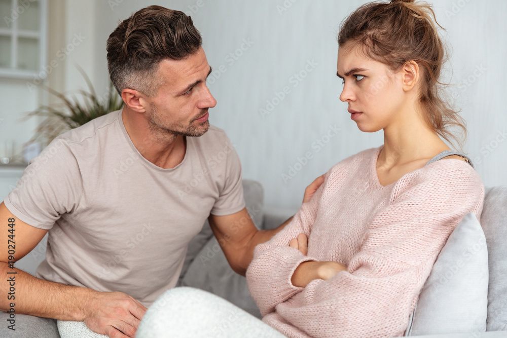 Side view of attentive man sitting on couch Side view of attentive man sitting on couch