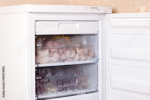 Assortment of frozen meat and dumplings in home fridge. Frozen food in the refrigerator.