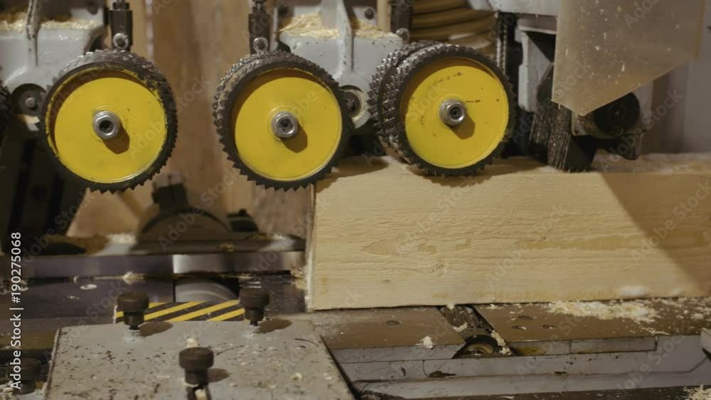 Wood block grinding in carpenter jointer machine at sawmill factory, lots of sawdust Wood block grinding in carpenter jointer machine at sawmill factory, lots of sawdust