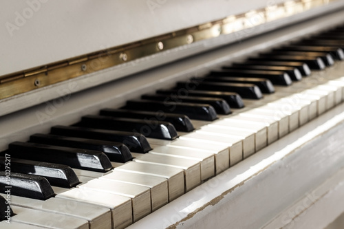 White piano, side view of instrument, musical instrument. learn to play the instrument at home. white large piano. piano keyboard. concert concept.