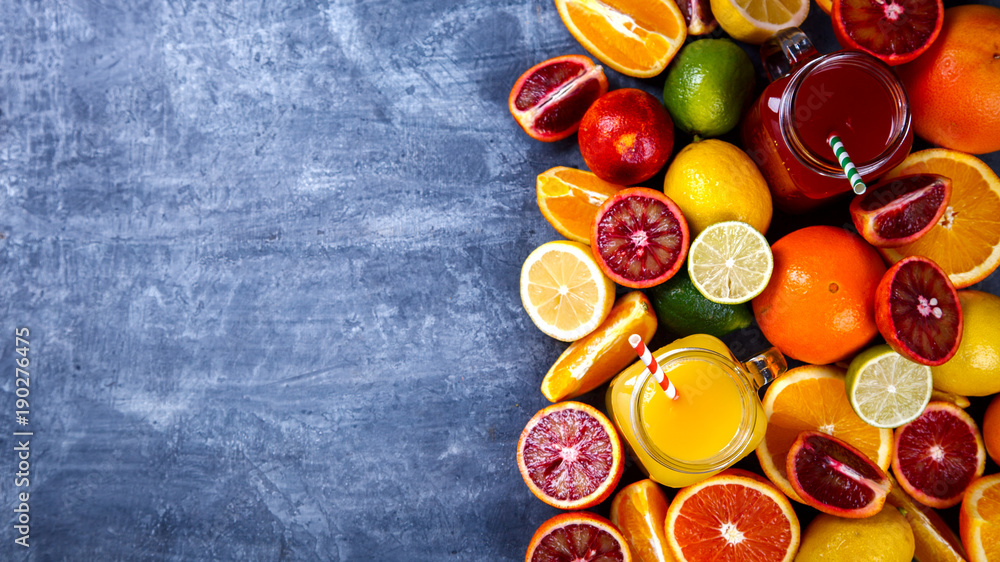 Juices Fresh Orange and Citrus.Healthy Beverage.Food or Healthy diet concept.Mixed Colorful Tropical Background.Copy space for Text. selective focus Juices Fresh Orange and Citrus.Healthy Beverage.Food or Healthy diet concept.Mixed Colorful Tropical Background.Copy space for Text. selective focus
