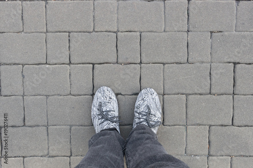Man legs on gray brick blocks
