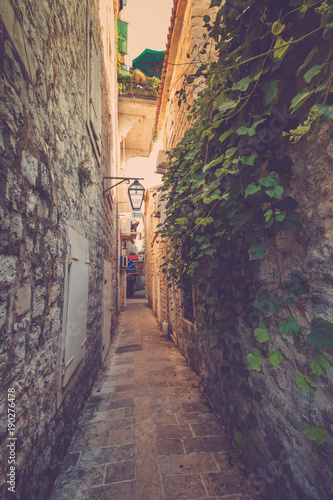 View narrow street in old town of Budva. Montenegro. Filtered image:cross processed vintage effect. © vovik_mar