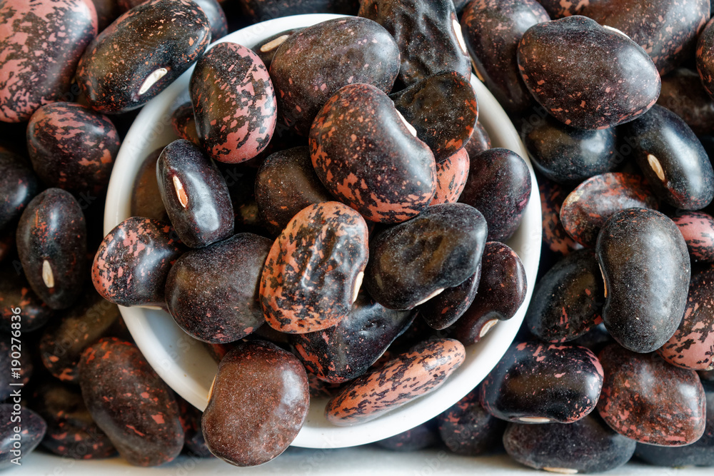 Dried kidney brown speckled beans The concept of proper nutrition and healthy lifestyle. Top view, close-up as background or texture Dried kidney brown speckled beans The concept of proper nutrition and healthy lifestyle. Top view, close-up as background or texture