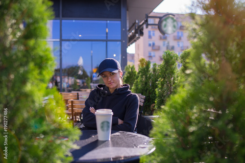 Tableau sur toile caucasian woman drinking hot beverage coffee outside