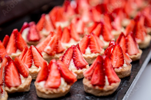 Canapes with strawberry dessert on the banquet table.