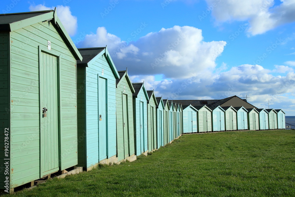 Row of colorful beach huts near Charmouth on the Jurassic Coast