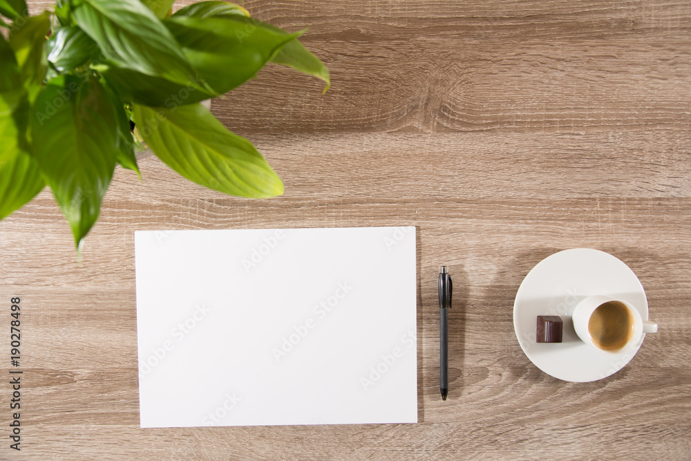 espresso on table with green plant, coffee beans and white blank paper and pen espresso on table with green plant, coffee beans and white blank paper and pen
